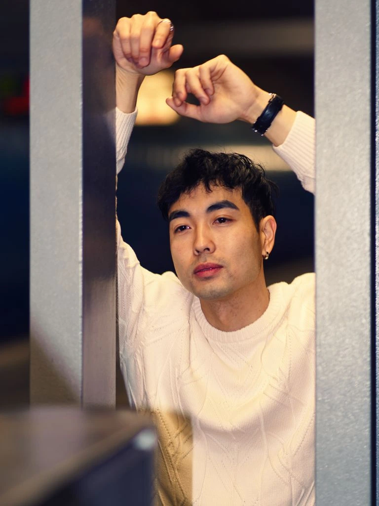 Portrait of curator Theo Nakamura at his desk.